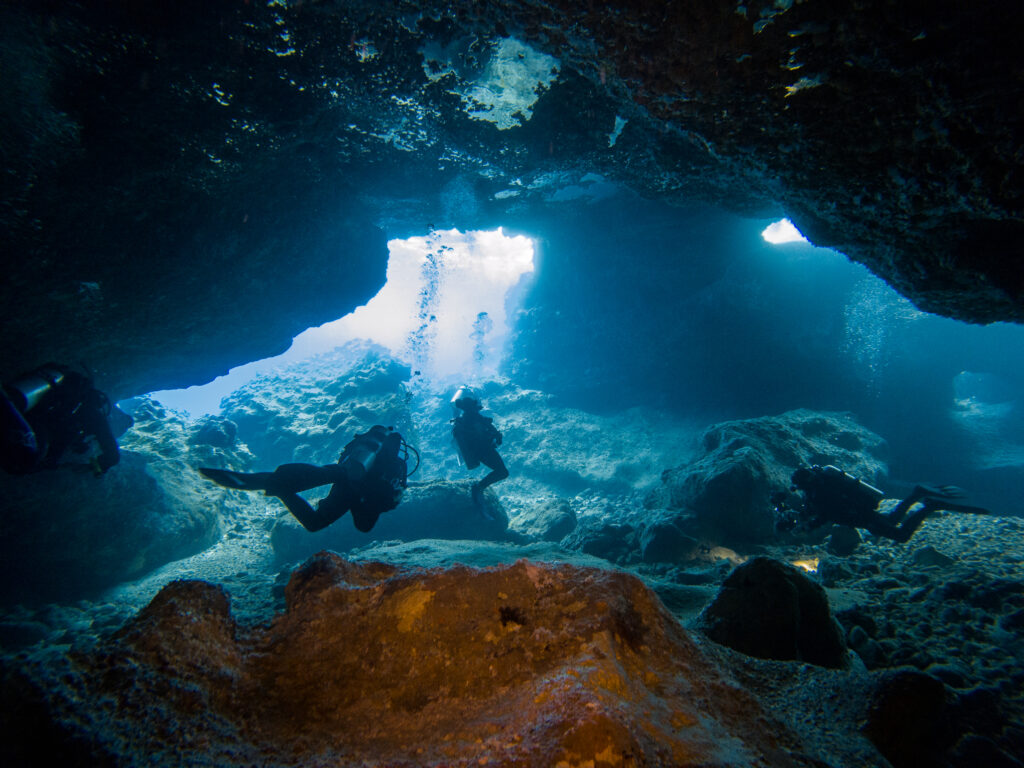 Scuba divers exiting Bubble Cave